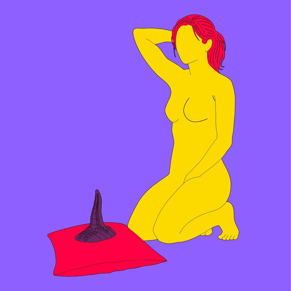 A naked illustrated woman knelt on the floor and touching herself, with a dildo propped on a pillow in front of her.